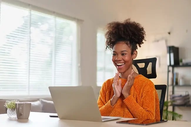 Woman smiling at her laptop