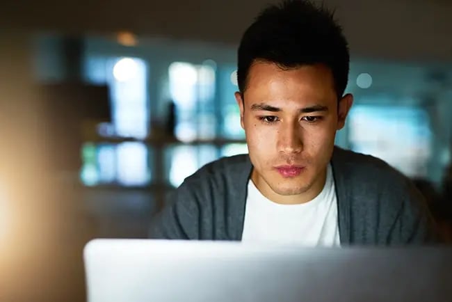 a man focusing on a task on his laptop