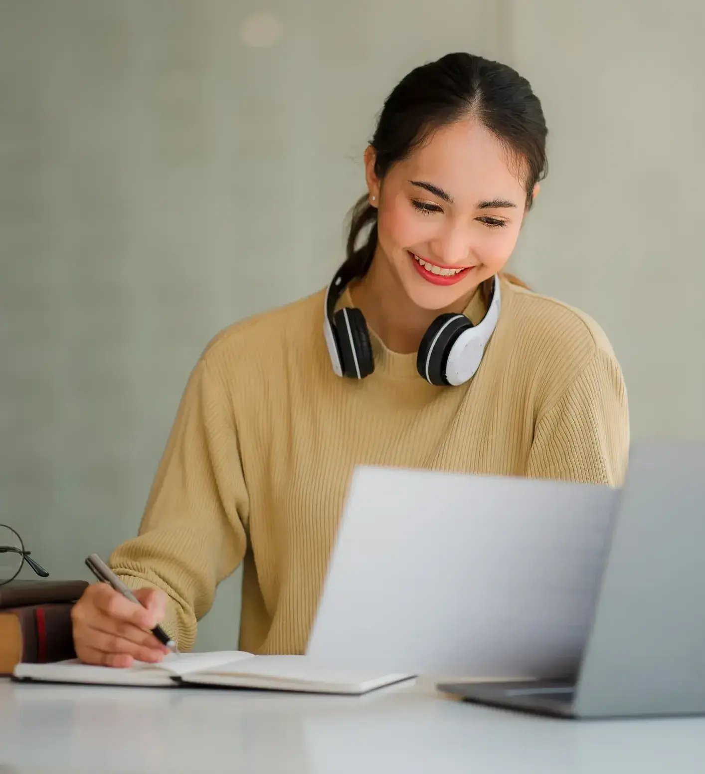 woman working on her laptop and smiling