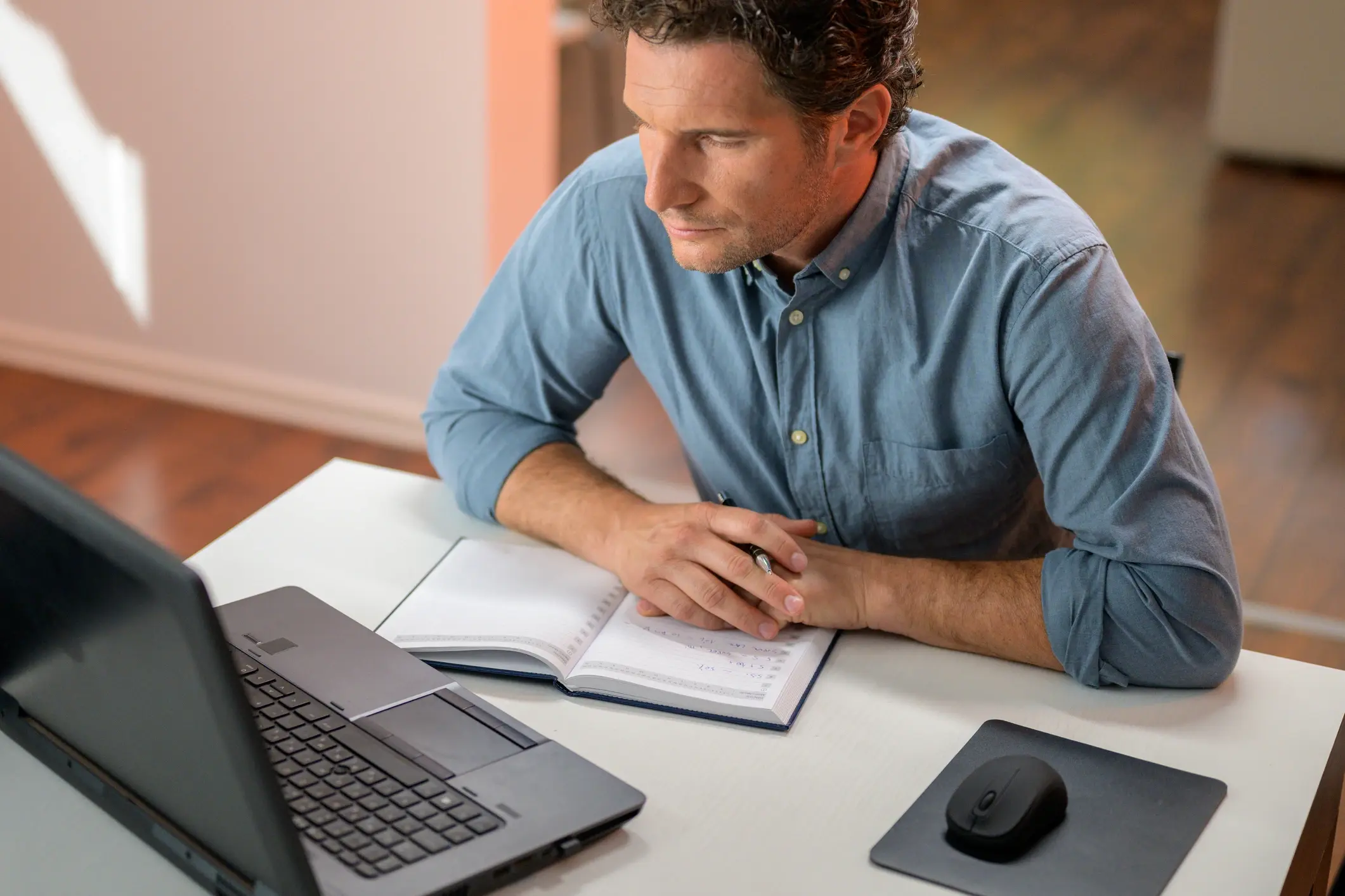 adult learner male working on his hnc on a laptop