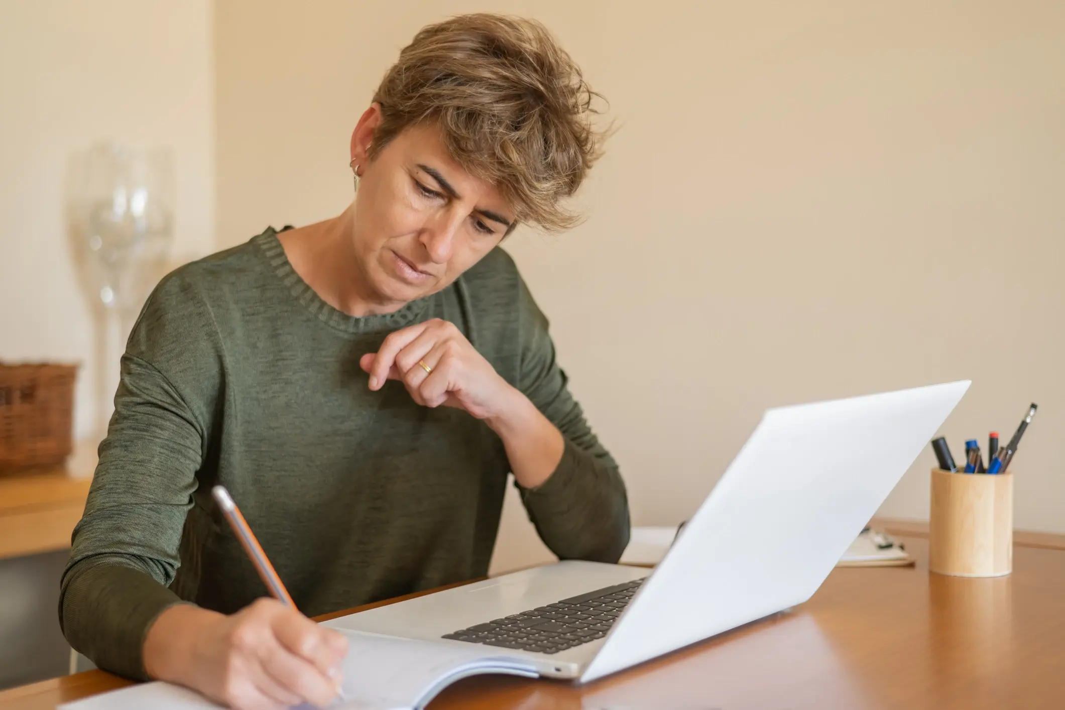 older woman doing her work on a laptop