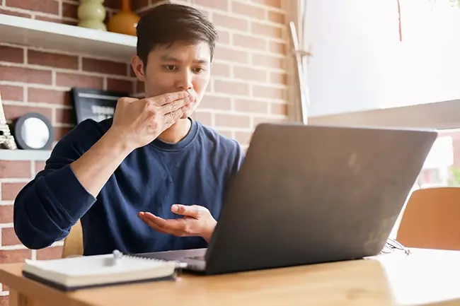 man using sign language at his laptop