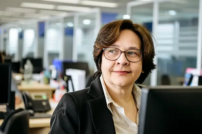 woman in an office looking to the side